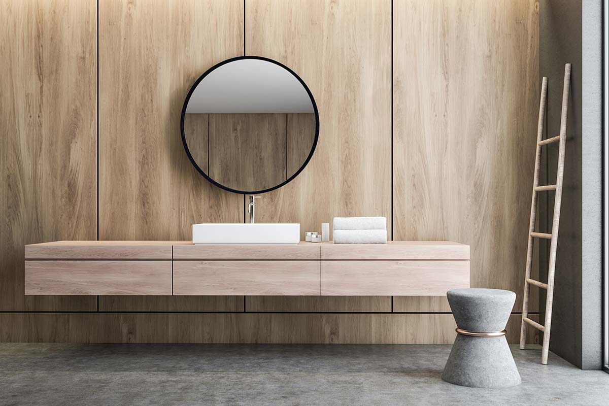 Okrągłe lustro łazienkowe Scandi w minimalistycznej łazience na tle drewnianego forniru. GieraDesign